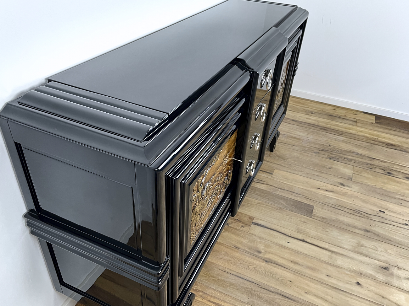 Art Deco sideboard around 1930 with two carved paintings